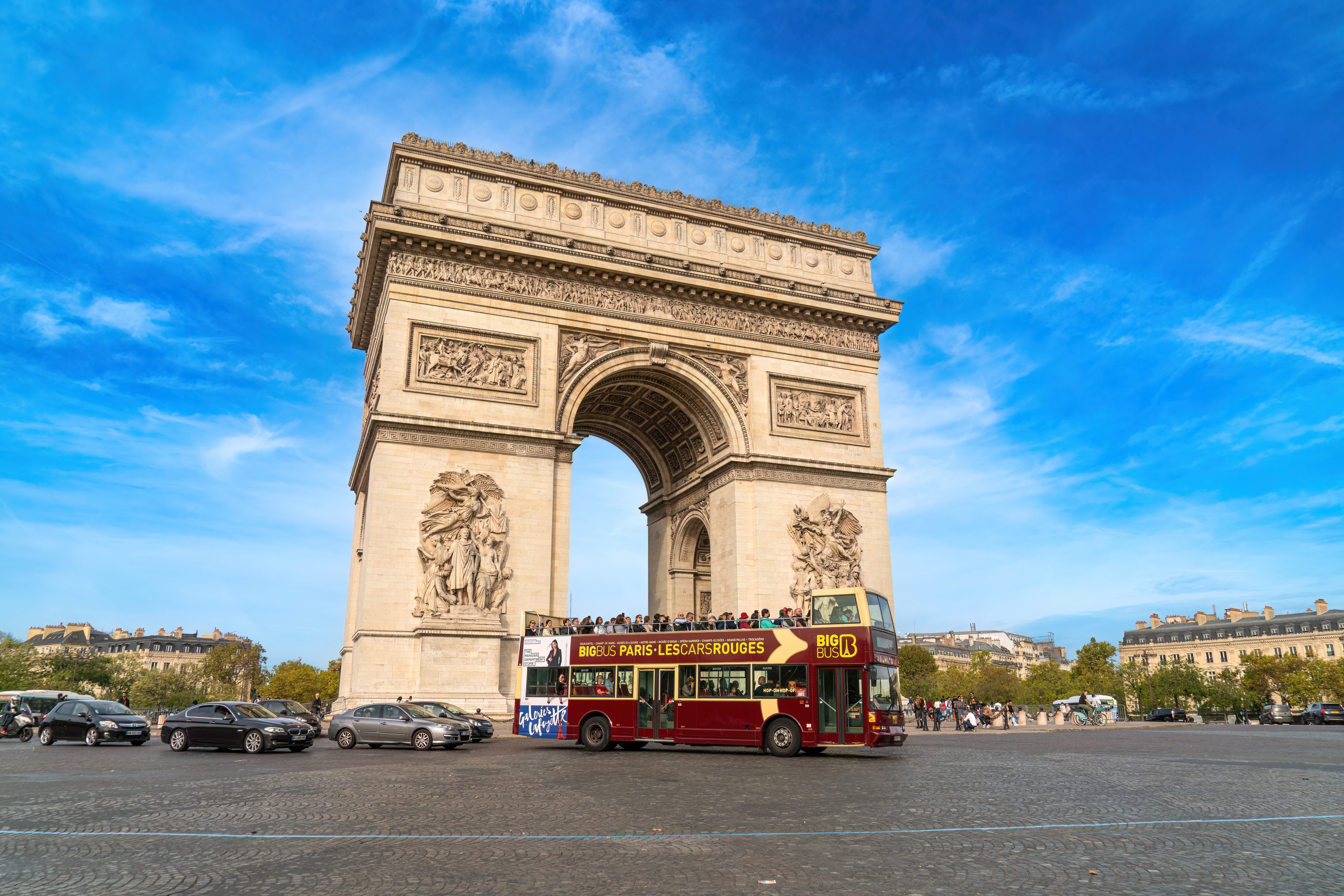 Hop on hop off tourist bus outside the Arc de Triomphe in Paris, France