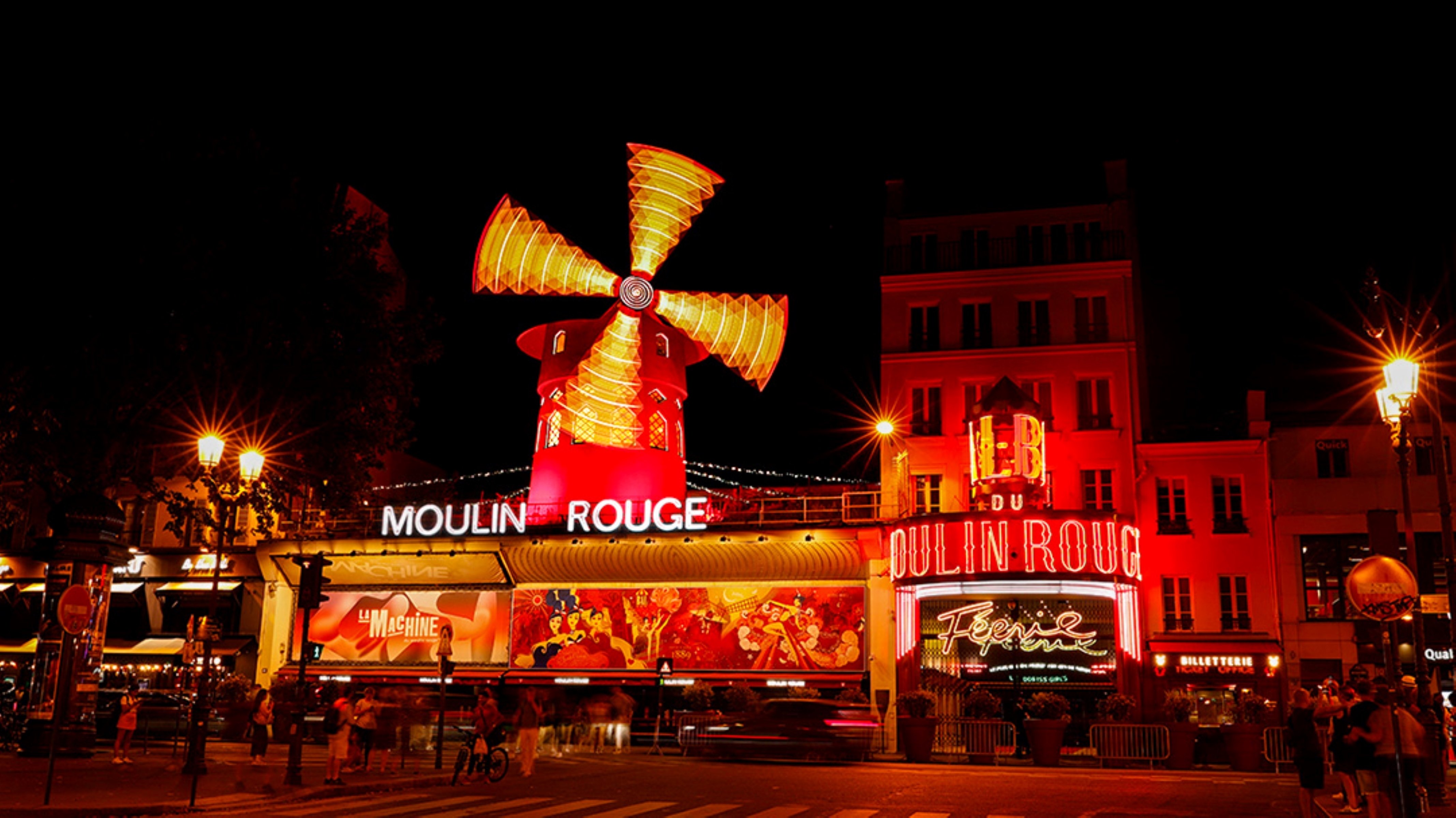 Moulin Rouge at night in Paris, France
