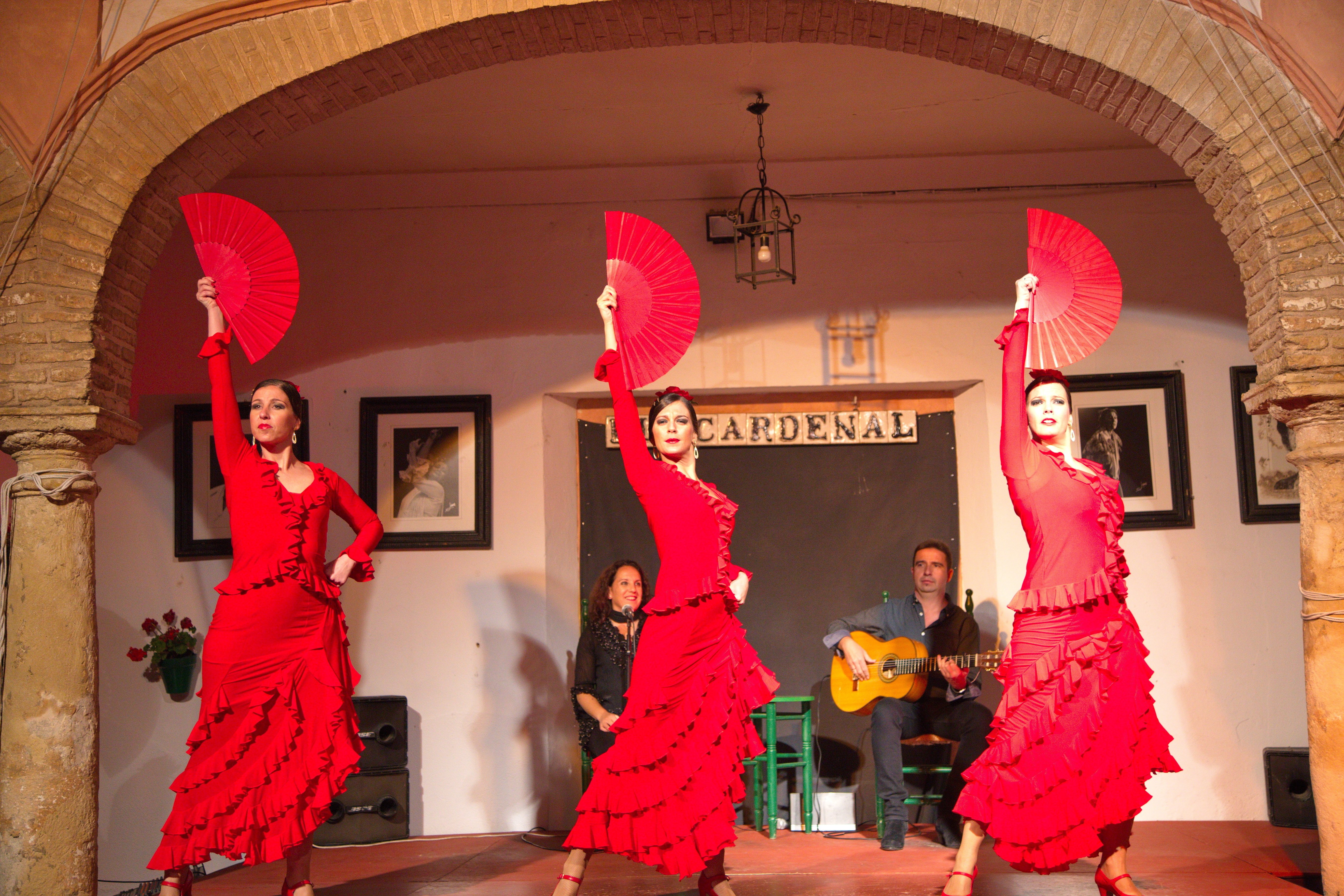 Three women in red at a flamenco show