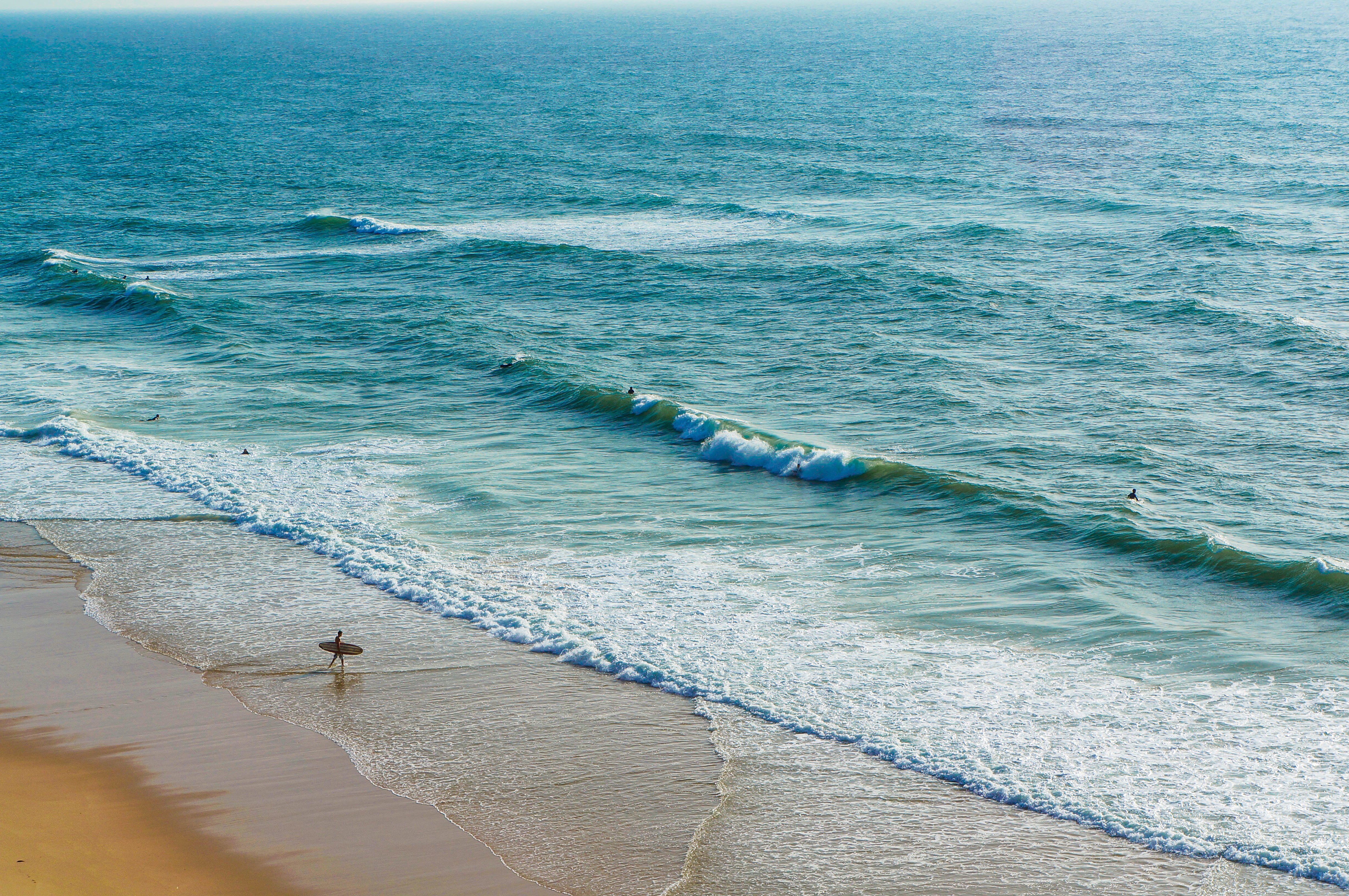 Surfer on a beach in Sintra, Portugal in November