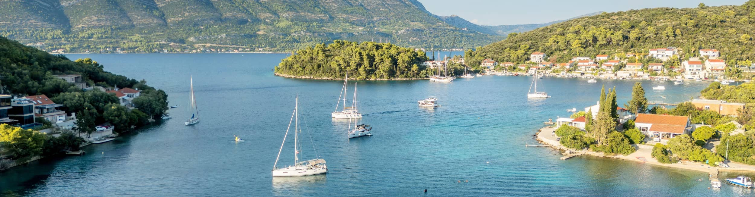 Boats dotting the clear waters around Korcula Island, Croatia
