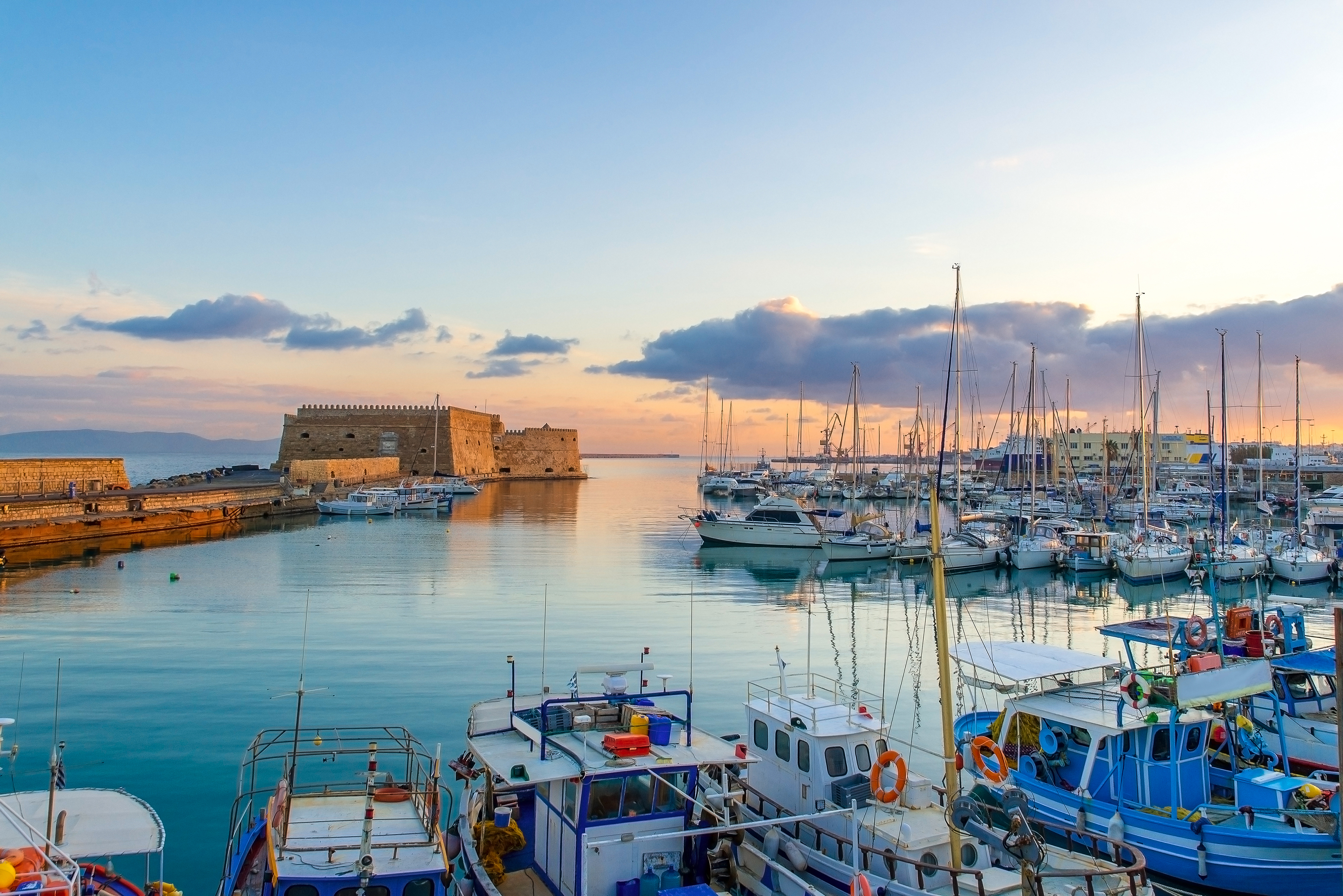 Fishing boats at the port in Heraklion, Crete at sunset