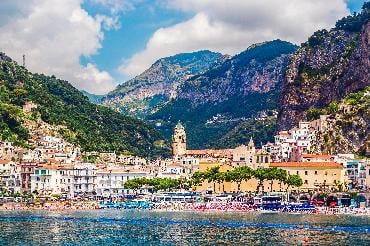 Skyline of colourful Amalfi town, backed by mountains