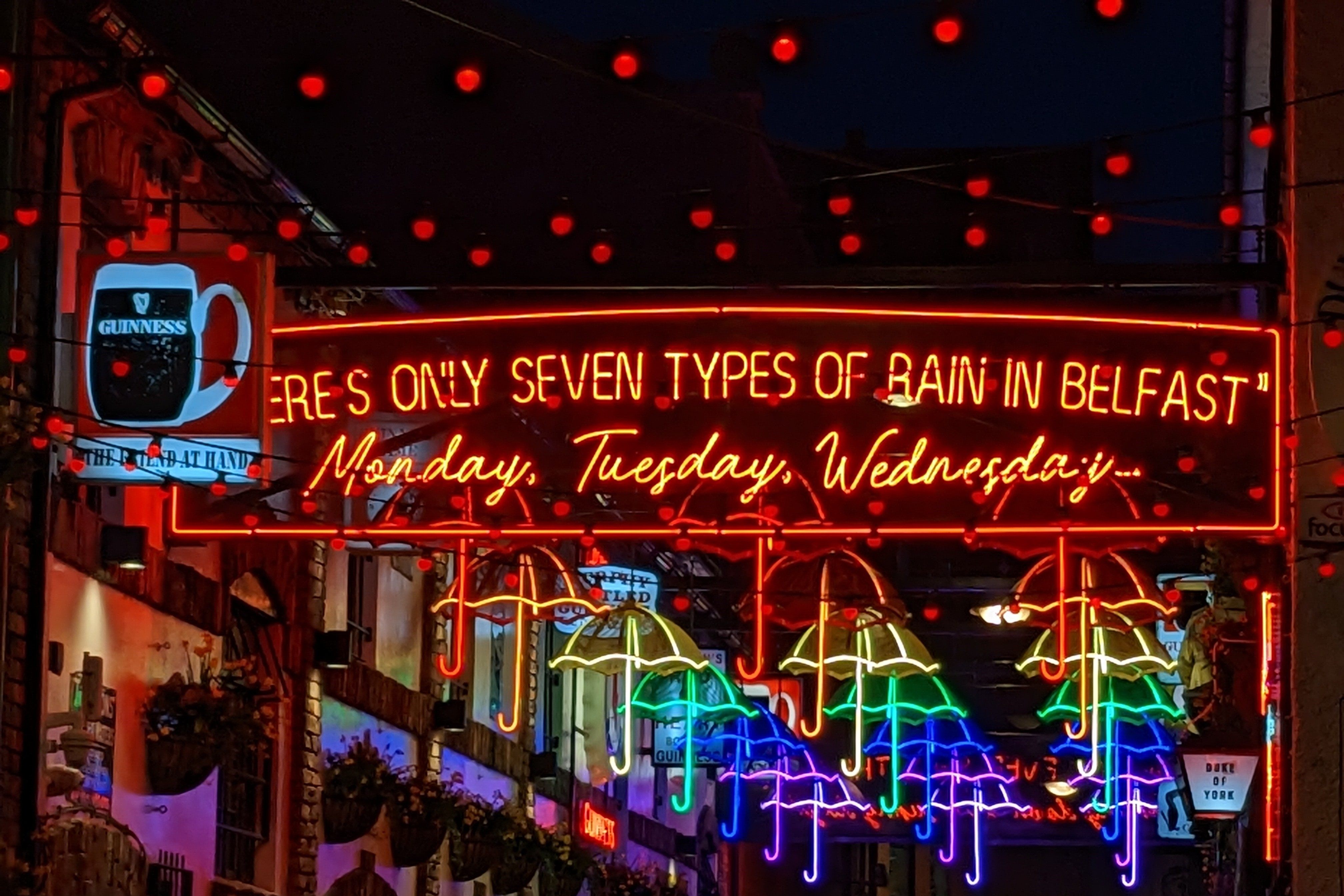 View of the artwork of Umbrella Street at night in Belfast, Ireland