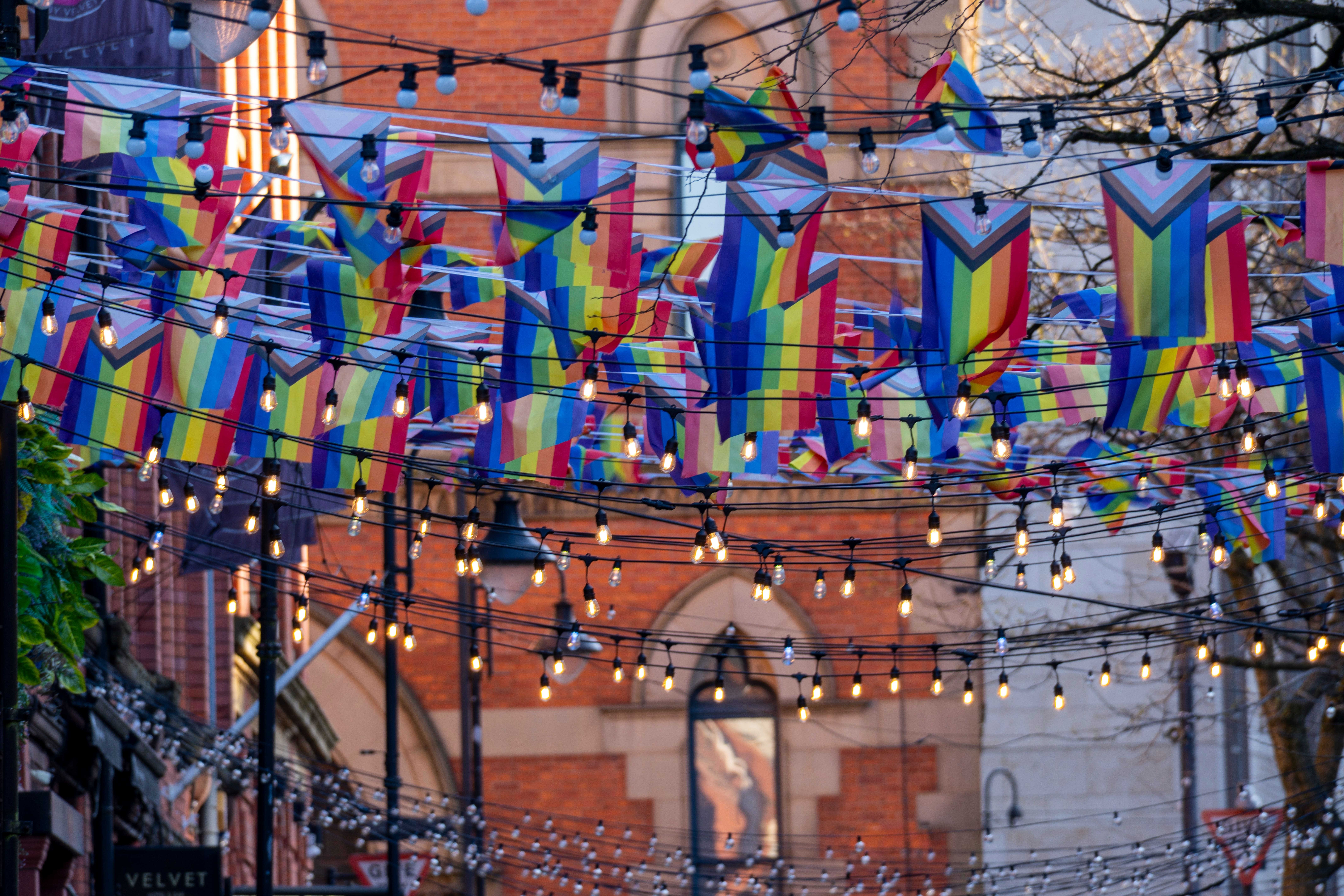 LGBTQ+ pride flags strung between buildings in Manchester's Gay Village, Canal Street