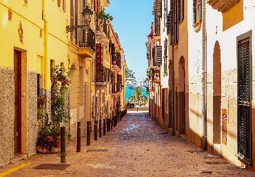 Colourful street in the Old Town of Palma, leading to the Mediterranean Sea on the island of Mallorca